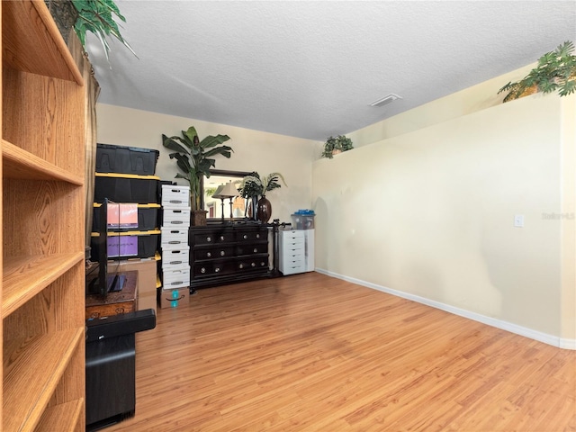 1319 Castleport Rd, Winter Garden, FL 34787 - bedroom with wood finished floors, baseboards, a textured ceiling, and arched walkways
