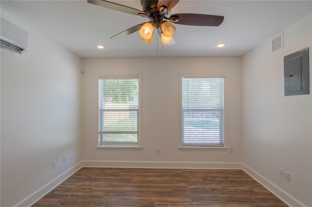 empty room featuring electric panel, wood finished floors, a ceiling fan, baseboards, and recessed lighting