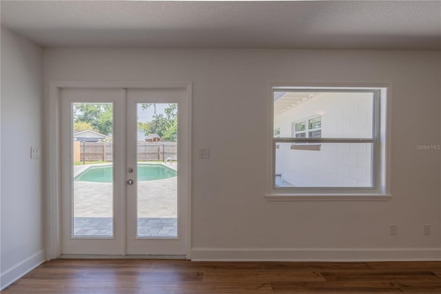 entryway featuring wood finished floors and baseboards