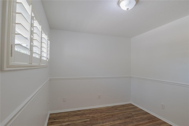 unfurnished room with wood finished floors and baseboards