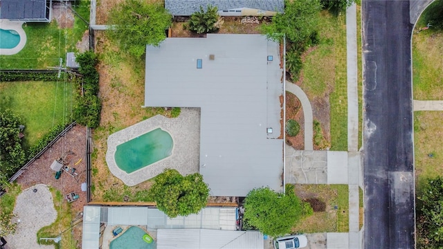 aerial view of property and surrounding area featuring a pool area