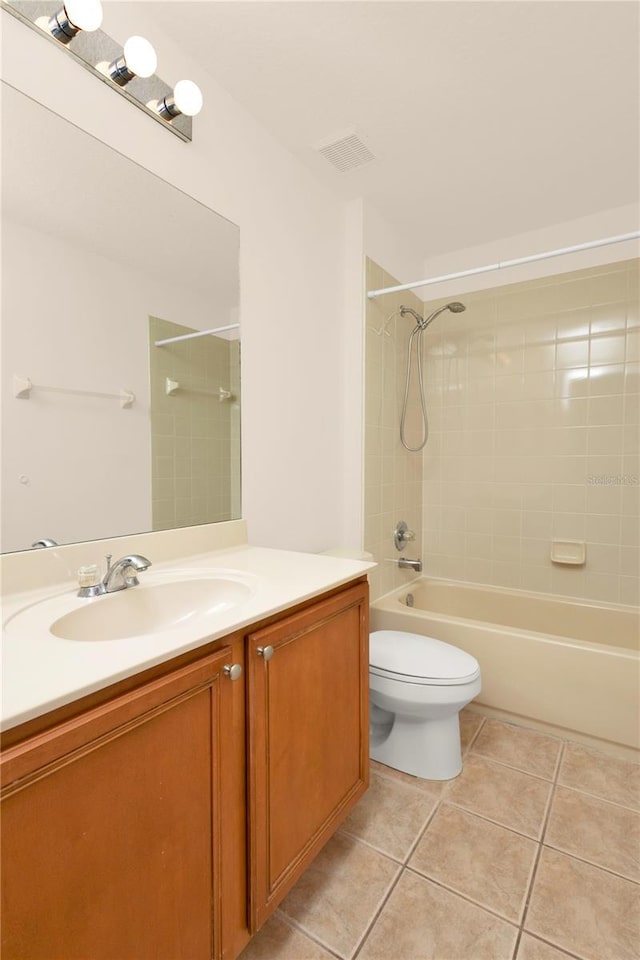 bathroom featuring tile patterned floors, vanity, toilet, and shower / washtub combination