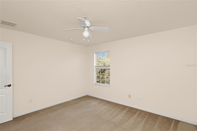 unfurnished room featuring light carpet, a ceiling fan, and baseboards