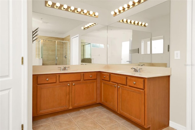 full bathroom featuring a shower stall, double vanity, and tile patterned floors