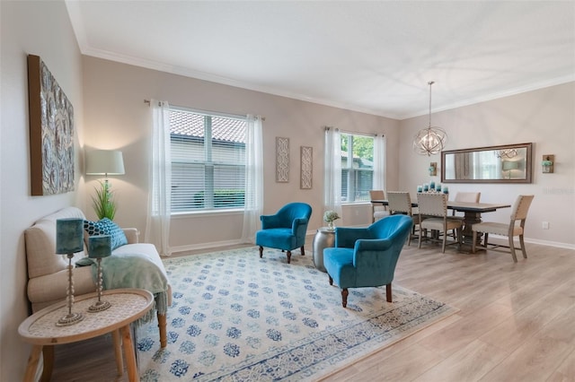 595 American Holly Pl, Oviedo, FL 32765 - living area featuring light wood-type flooring, baseboards, crown molding, and a chandelier