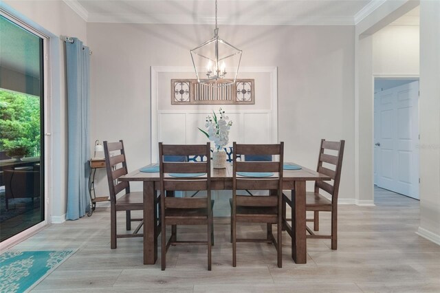 595 American Holly Pl, Oviedo, FL 32765 - dining room featuring a chandelier, ornamental molding, light wood finished floors, and baseboards