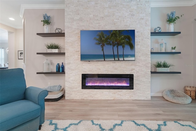 595 American Holly Pl, Oviedo, FL 32765 - living area with a stone fireplace, ornamental molding, wood finished floors, and recessed lighting