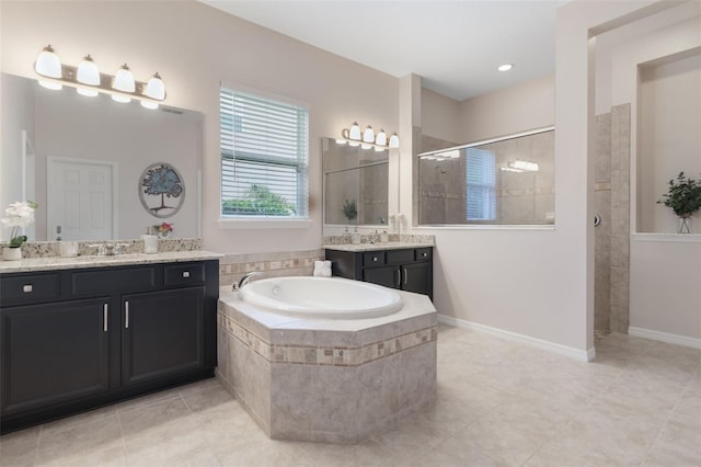 595 American Holly Pl, Oviedo, FL 32765 - full bathroom featuring walk in shower, a bath, two vanities, and tile patterned floors