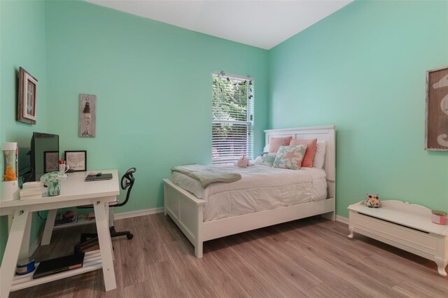 595 American Holly Pl, Oviedo, FL 32765 - bedroom with wood finished floors, baseboards, and a desk