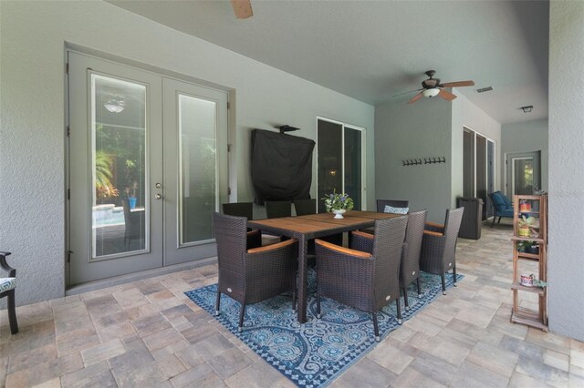 595 American Holly Pl, Oviedo, FL 32765 - dining room featuring french doors, a ceiling fan, stone finish floors, and a textured wall