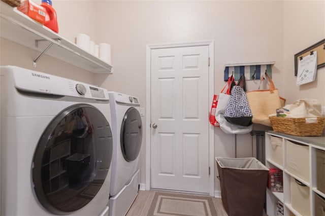 595 American Holly Pl, Oviedo, FL 32765 - laundry room with washing machine and dryer and light wood finished floors