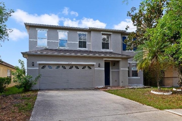 view of front of house featuring stucco siding, a garage, and concrete driveway