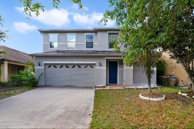 view of front of house featuring a garage, stucco siding, and driveway