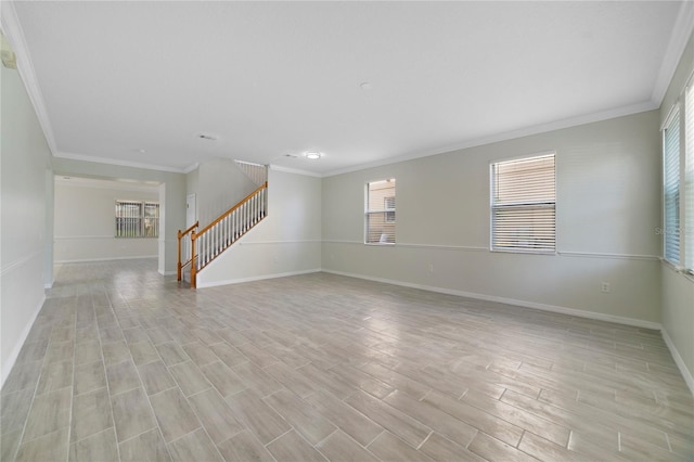 unfurnished living room featuring baseboards, stairs, crown molding, plenty of natural light, and light wood finished floors