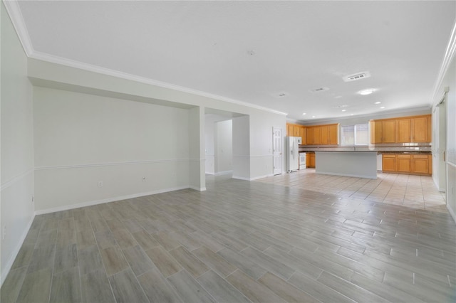 unfurnished living room with crown molding, baseboards, light wood-style flooring, and recessed lighting