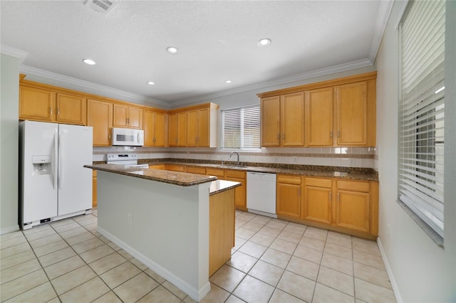 kitchen featuring white appliances, light tile patterned flooring, ornamental molding, a center island, and a sink
