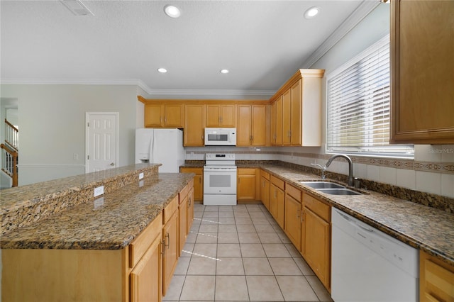 kitchen featuring white appliances, a sink, ornamental molding, backsplash, and a kitchen island