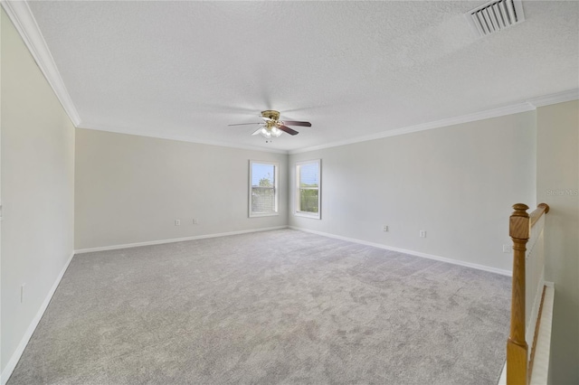carpeted empty room featuring crown molding, ceiling fan, a textured ceiling, and baseboards