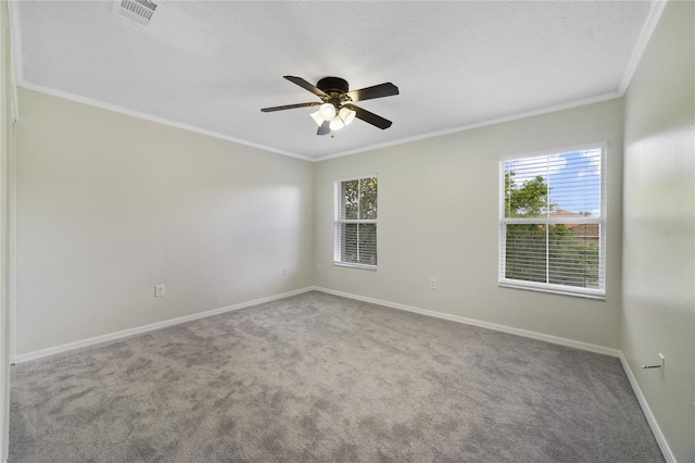 spare room with carpet flooring, plenty of natural light, baseboards, crown molding, and ceiling fan