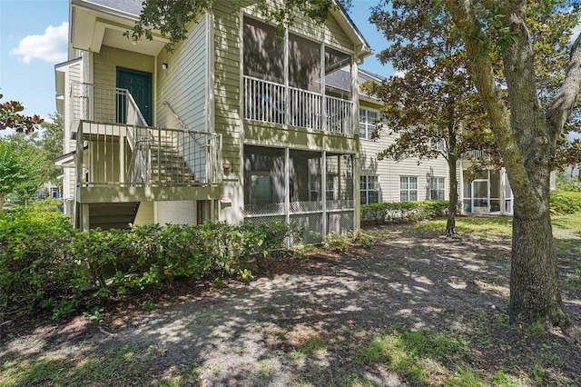 3721 S Lake Orlando Pkwy Unit 05, Orlando, FL 32808 - rear view of property featuring a sunroom