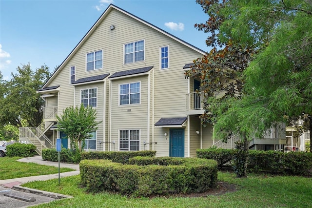 3721 S Lake Orlando Pkwy Unit 05, Orlando, FL 32808 - view of front facade with a balcony and stairway