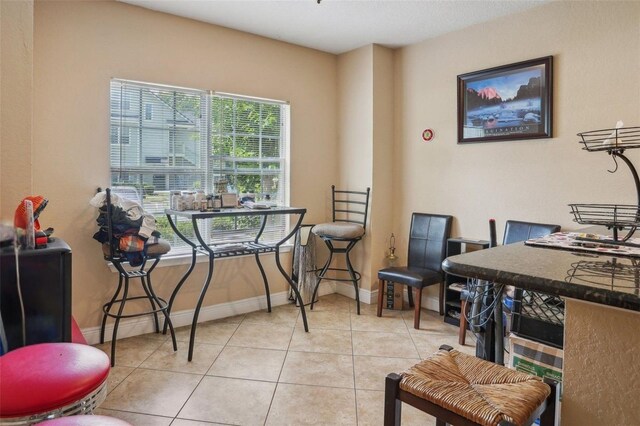 3721 S Lake Orlando Pkwy Unit 05, Orlando, FL 32808 - office area with baseboards and light tile patterned flooring