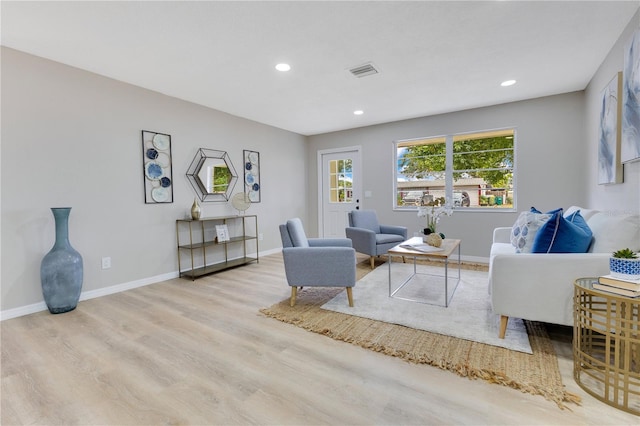 living area with wood finished floors, recessed lighting, and baseboards