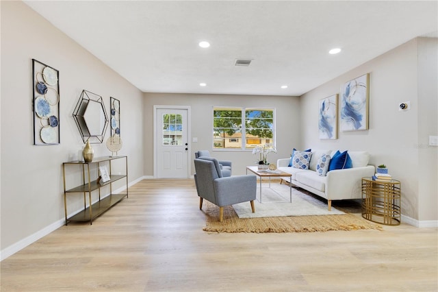living area featuring wood finished floors, baseboards, and recessed lighting