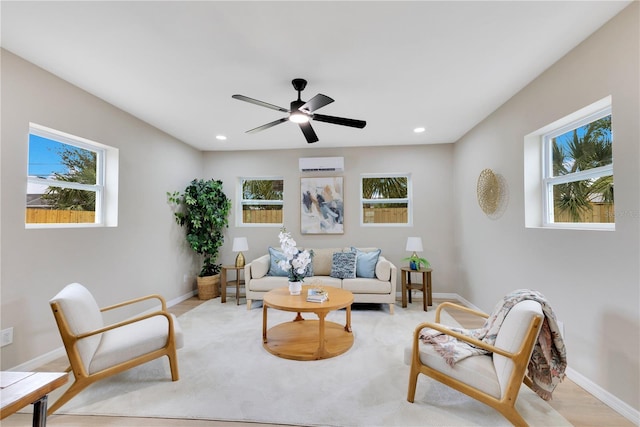 living room with healthy amount of natural light, a wall mounted AC, recessed lighting, and baseboards