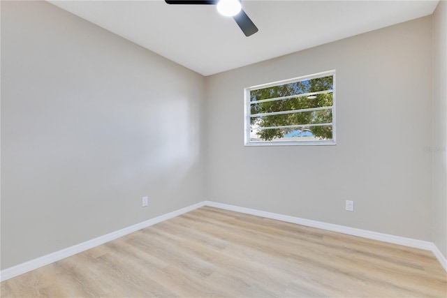 unfurnished room with a ceiling fan, light wood-type flooring, and baseboards