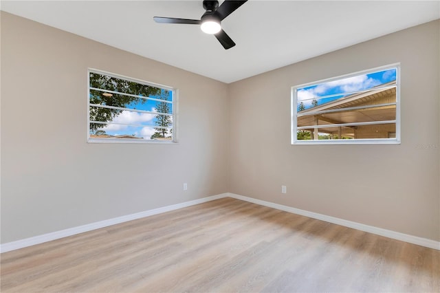 unfurnished room featuring light wood-type flooring, baseboards, and ceiling fan