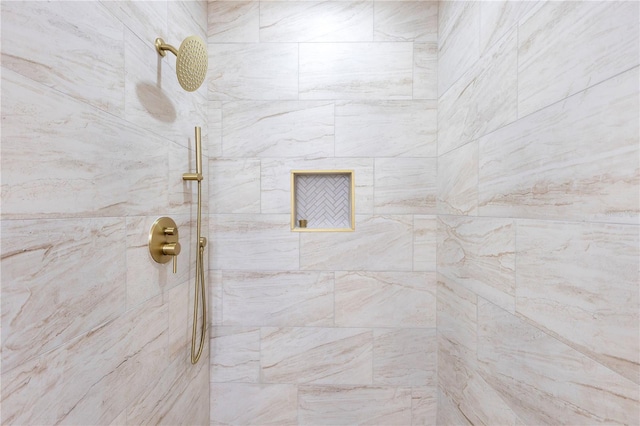bathroom with a tile shower