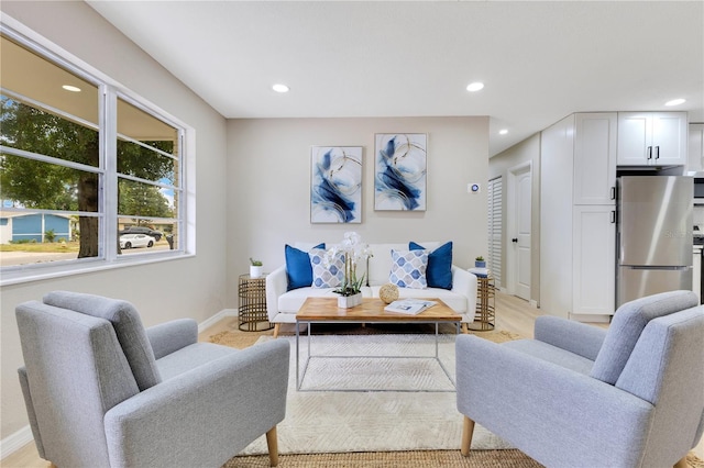 living area featuring baseboards and recessed lighting