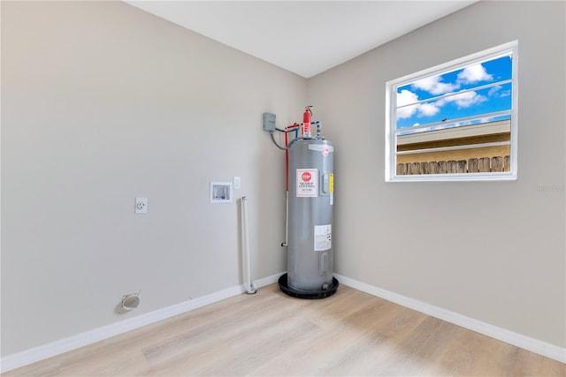 utility room featuring water heater