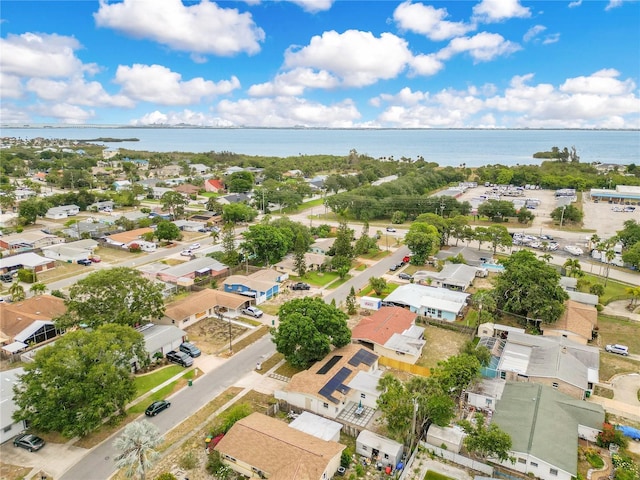 aerial overview of property's location featuring nearby suburban area and a nearby body of water