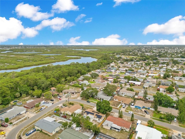 aerial overview of property's location with a large body of water and nearby suburban area