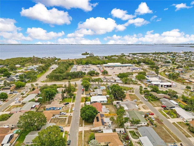aerial overview of property's location with a nearby body of water and nearby suburban area