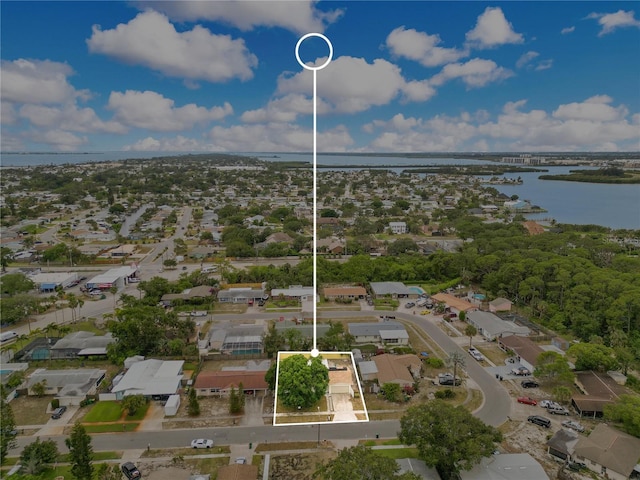 aerial view of property's location with a large body of water, property parcel outlined, and nearby suburban area