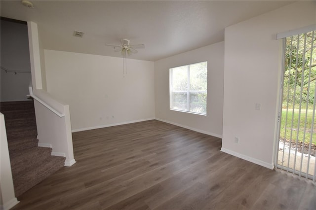 unfurnished living room featuring a ceiling fan, plenty of natural light, and wood finished floors
