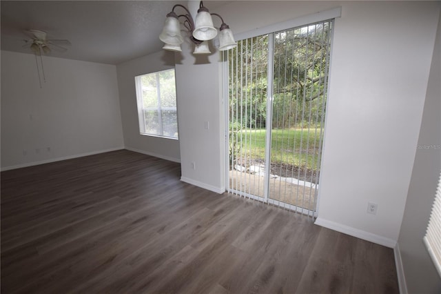 unfurnished dining area with a chandelier, healthy amount of natural light, and wood finished floors