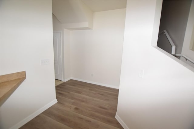 hall with wood finished floors and baseboards