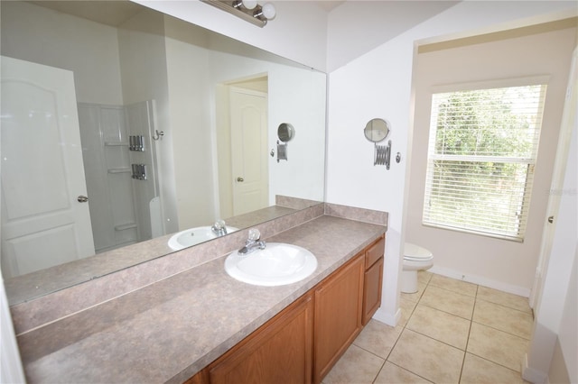 bathroom with toilet, a shower, tile patterned floors, vanity, and baseboards