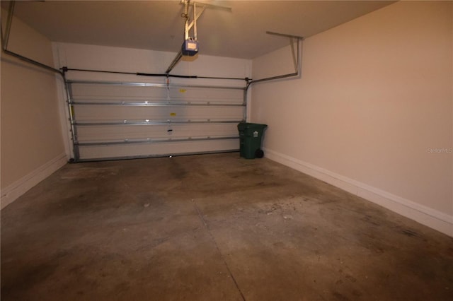 garage featuring baseboards and a garage door opener