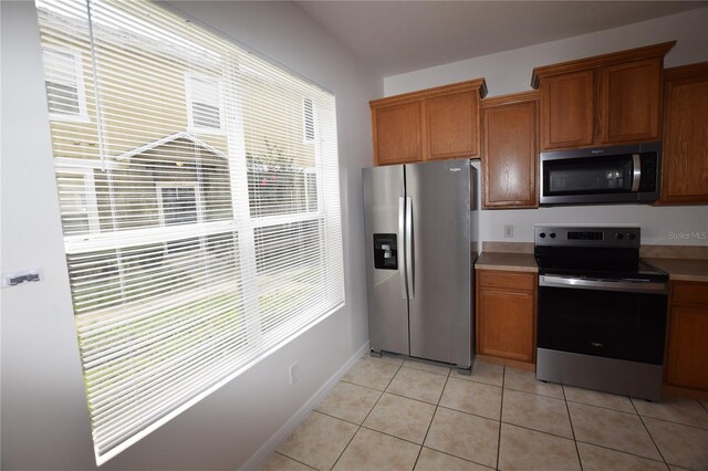 15349 Oak Apple Ct, Winter Garden, FL 34787 - kitchen with stainless steel appliances, light countertops, and brown cabinetry