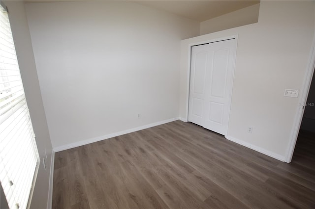 15349 Oak Apple Ct, Winter Garden, FL 34787 - unfurnished bedroom featuring dark wood-style flooring, baseboards, and a closet