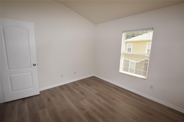 15349 Oak Apple Ct, Winter Garden, FL 34787 - spare room featuring vaulted ceiling, wood finished floors, and baseboards