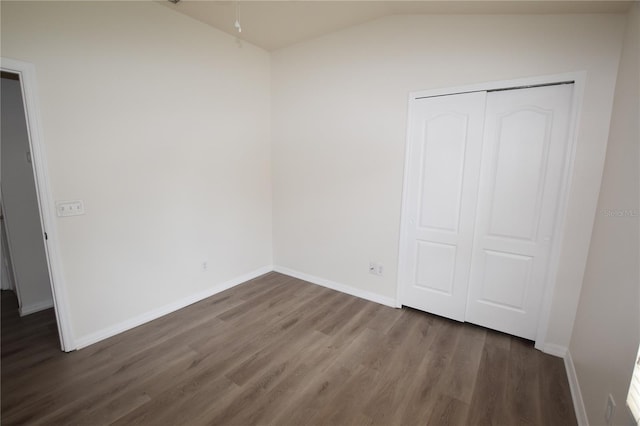 15349 Oak Apple Ct, Winter Garden, FL 34787 - unfurnished bedroom with wood finished floors, vaulted ceiling, a closet, and baseboards