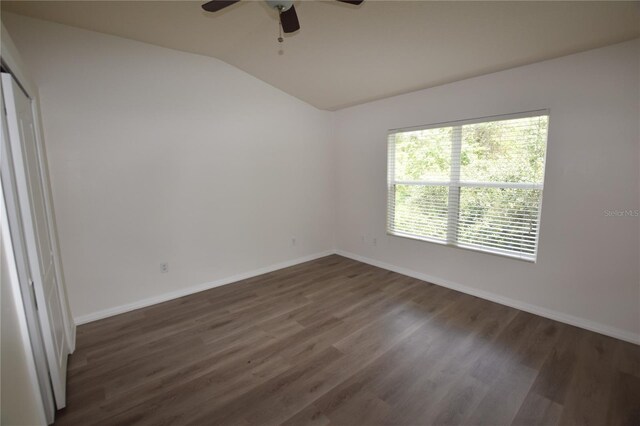 15349 Oak Apple Ct, Winter Garden, FL 34787 - spare room with vaulted ceiling, baseboards, a ceiling fan, and dark wood finished floors