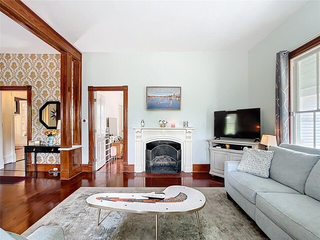 511 E Mirror Lake Dr, Fruitland Park, FL 34731 - living area featuring wood finished floors, baseboards, a fireplace, and wallpapered walls