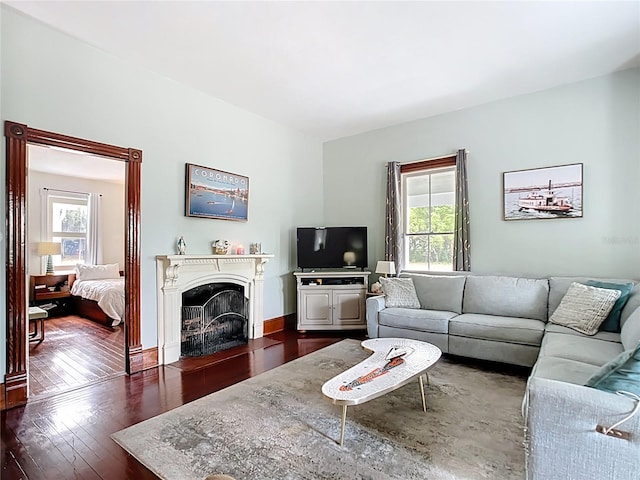 511 E Mirror Lake Dr, Fruitland Park, FL 34731 - living room featuring plenty of natural light, dark wood-type flooring, and a fireplace